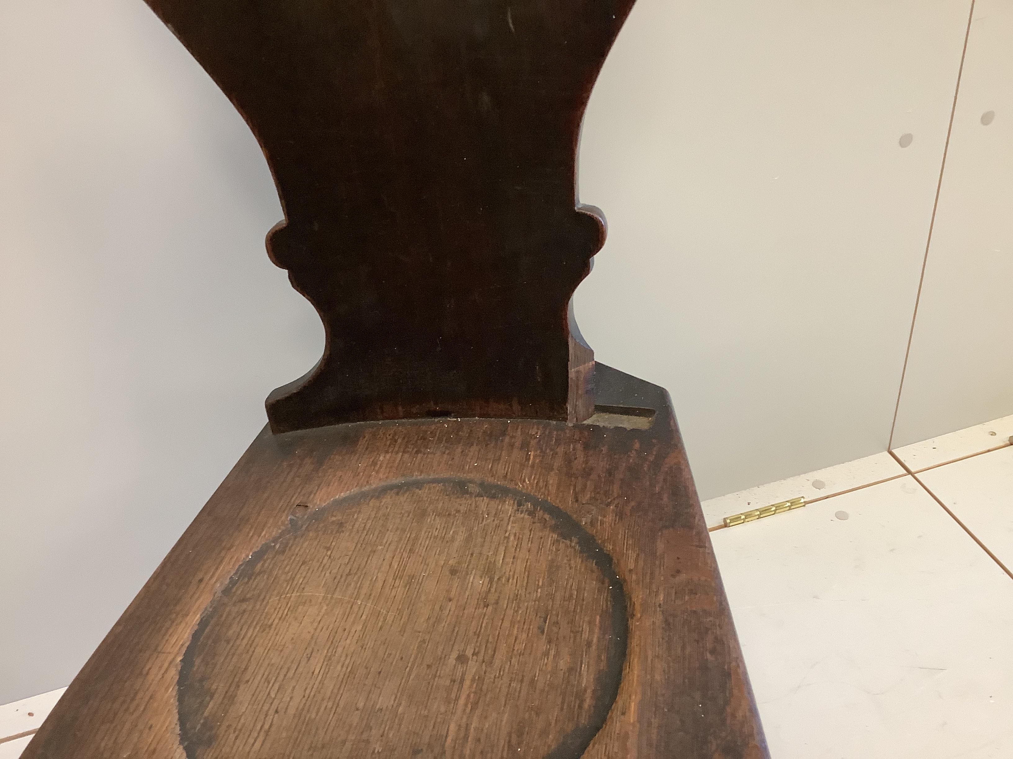 A pair of George III 'Sgabello' style oak hall chairs, width 38cm, depth 48cm, height 94cm